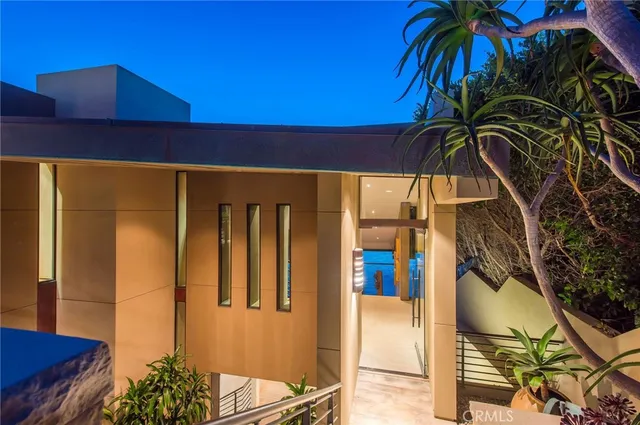 a kitchen with stainless steel appliances granite countertop a sink counter space and chairs