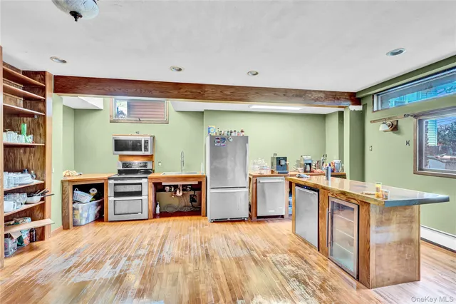 a kitchen with stainless steel appliances a stove top oven and a refrigerator