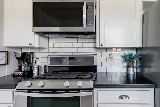a kitchen with a stove and a microwave