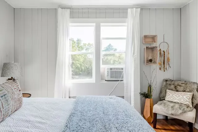 a bedroom with a balcony a bed and a couch