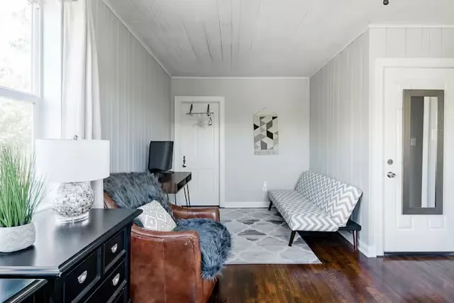 a living room with furniture and wooden floor