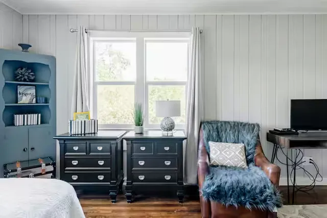 a bedroom with a bed and a television