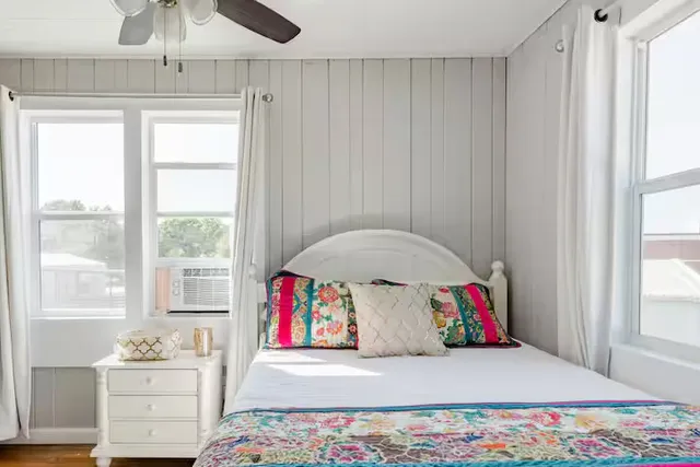 a bedroom with a bed and a window