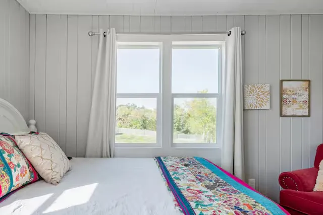 a bedroom with a bed and a window