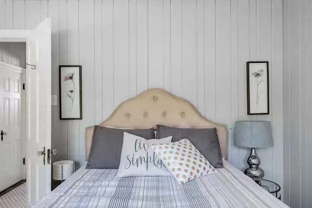 a view of a bedroom with wooden floor and bathroom