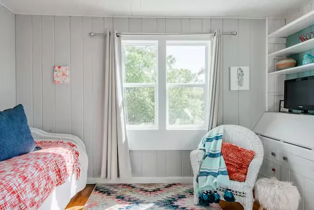 a bedroom with a bed and a window
