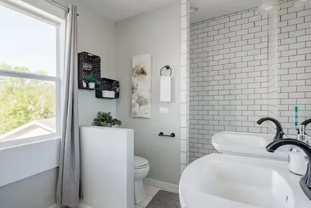 a bathroom with a toilet sink and mirror
