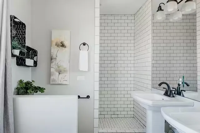 a bathroom with a sink a mirror and shower