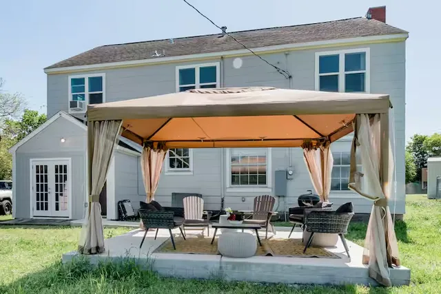 a house view with a seating space and a garden
