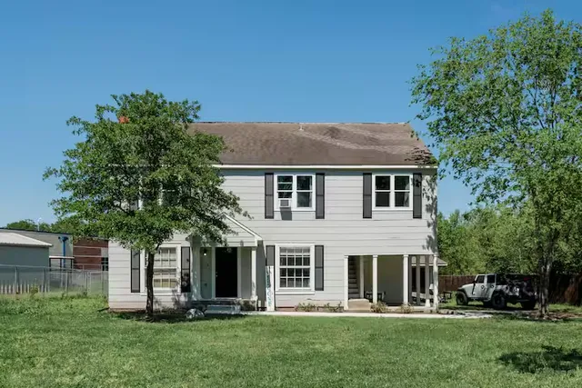 a front view of a house with a garden