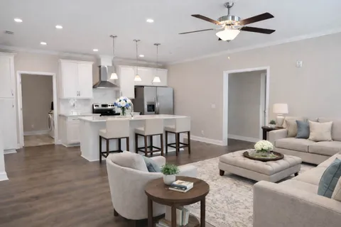 a open kitchen with stainless steel appliances kitchen island a white counter space a sink and living room view