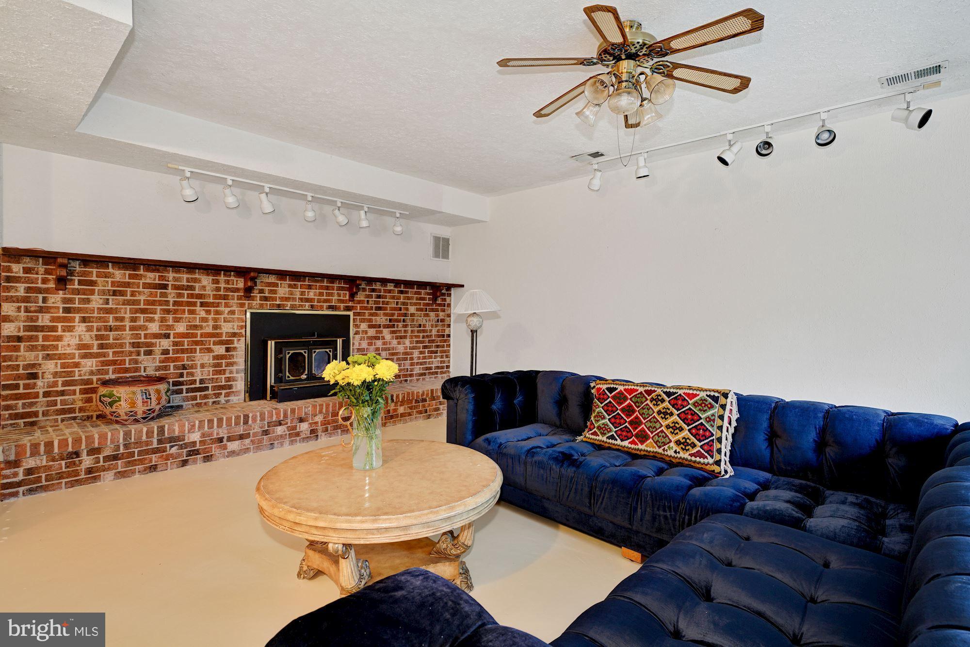 6 Travilah Terrace Potomac, MD 20854 - Photo 40 of 49 Brick Wood-Burning Fireplace and Concrete Floors