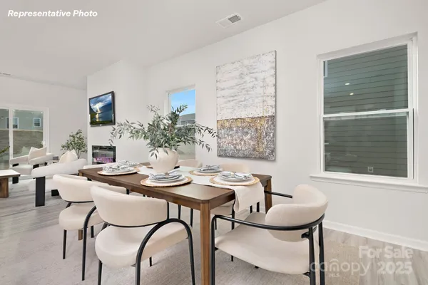a view of a dining room with furniture and window
