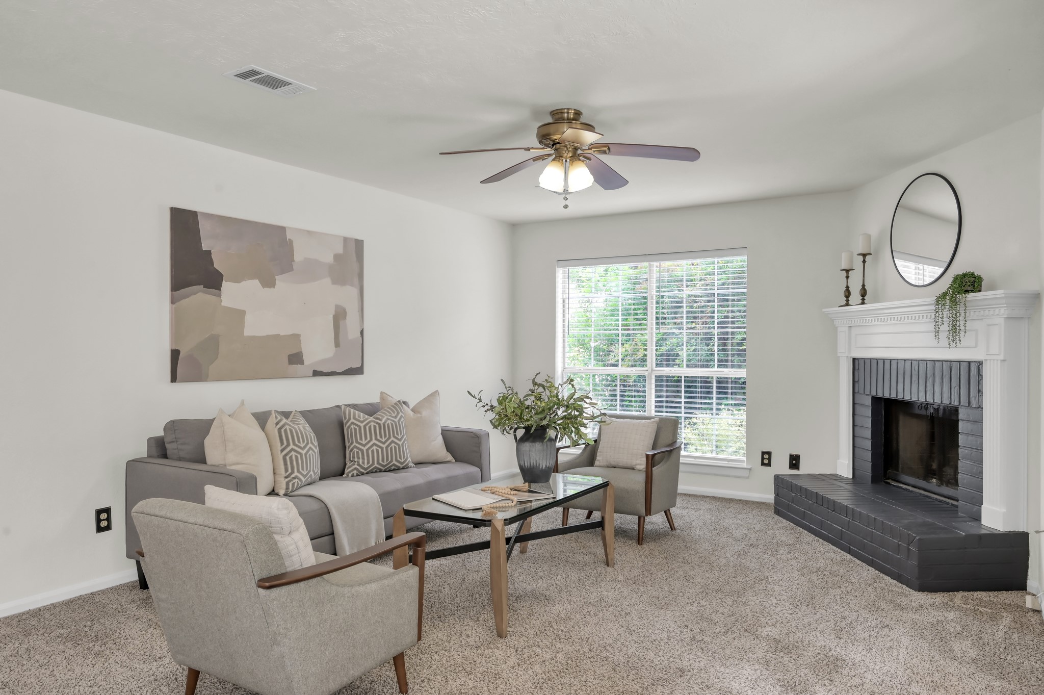 114 Regency Way Conroe, TX 77304 - Photo 13 of 48 Spacious, light and bright living room with cozy wood/gas fire place, double doors leading to covered back patio and ceiling fan.