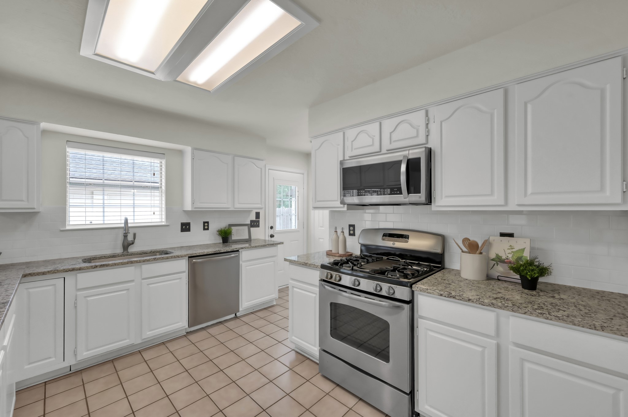 114 Regency Way Conroe, TX 77304 - Photo 16 of 48 Recently updated kitchen with stainless steel applicances and granite countertops open to the breakfast area and living room.