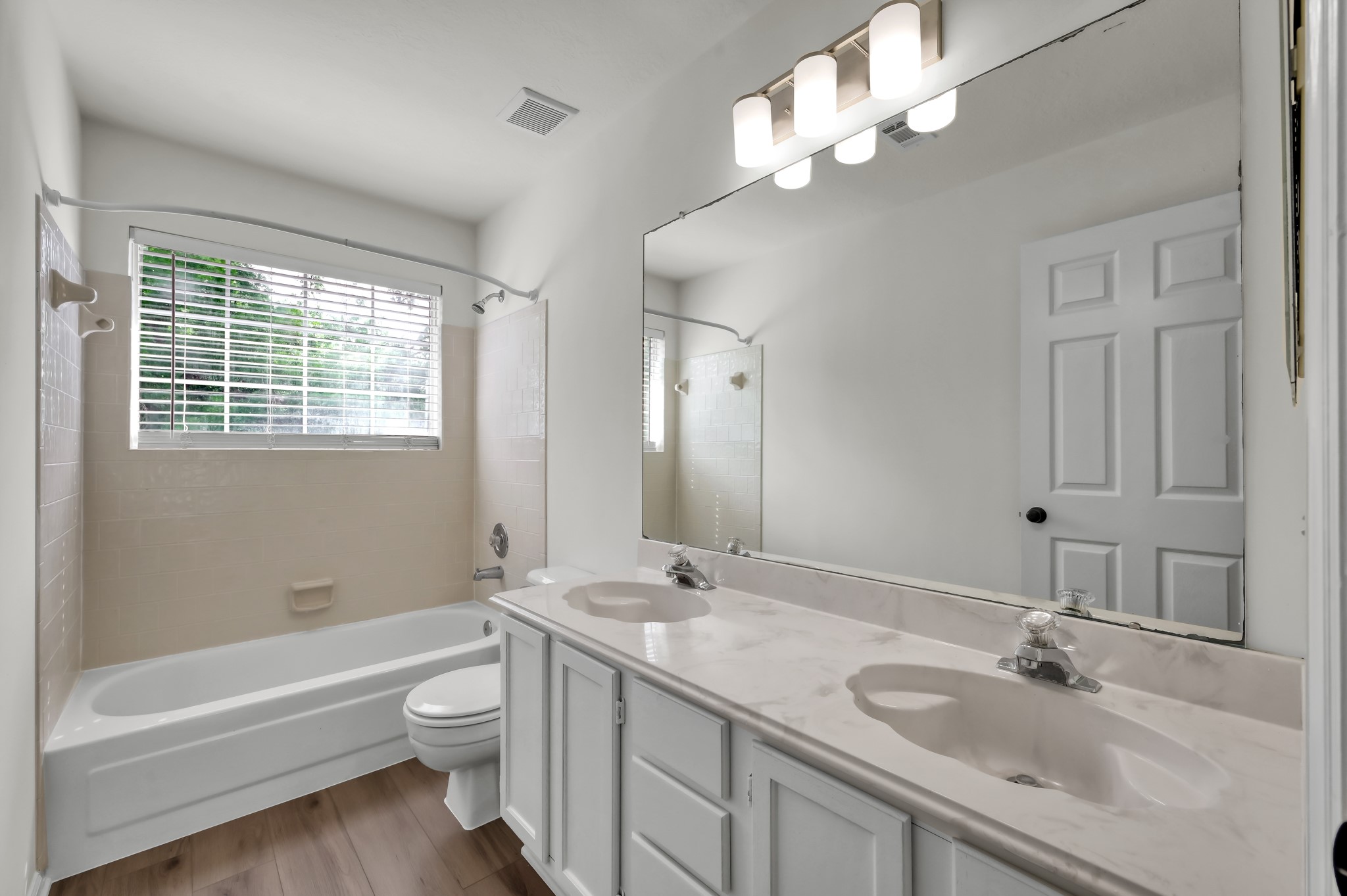 114 Regency Way Conroe, TX 77304 - Photo 36 of 48 Secondary upstairs bath with recent luxury vinyl plank flooring and updated lighting.