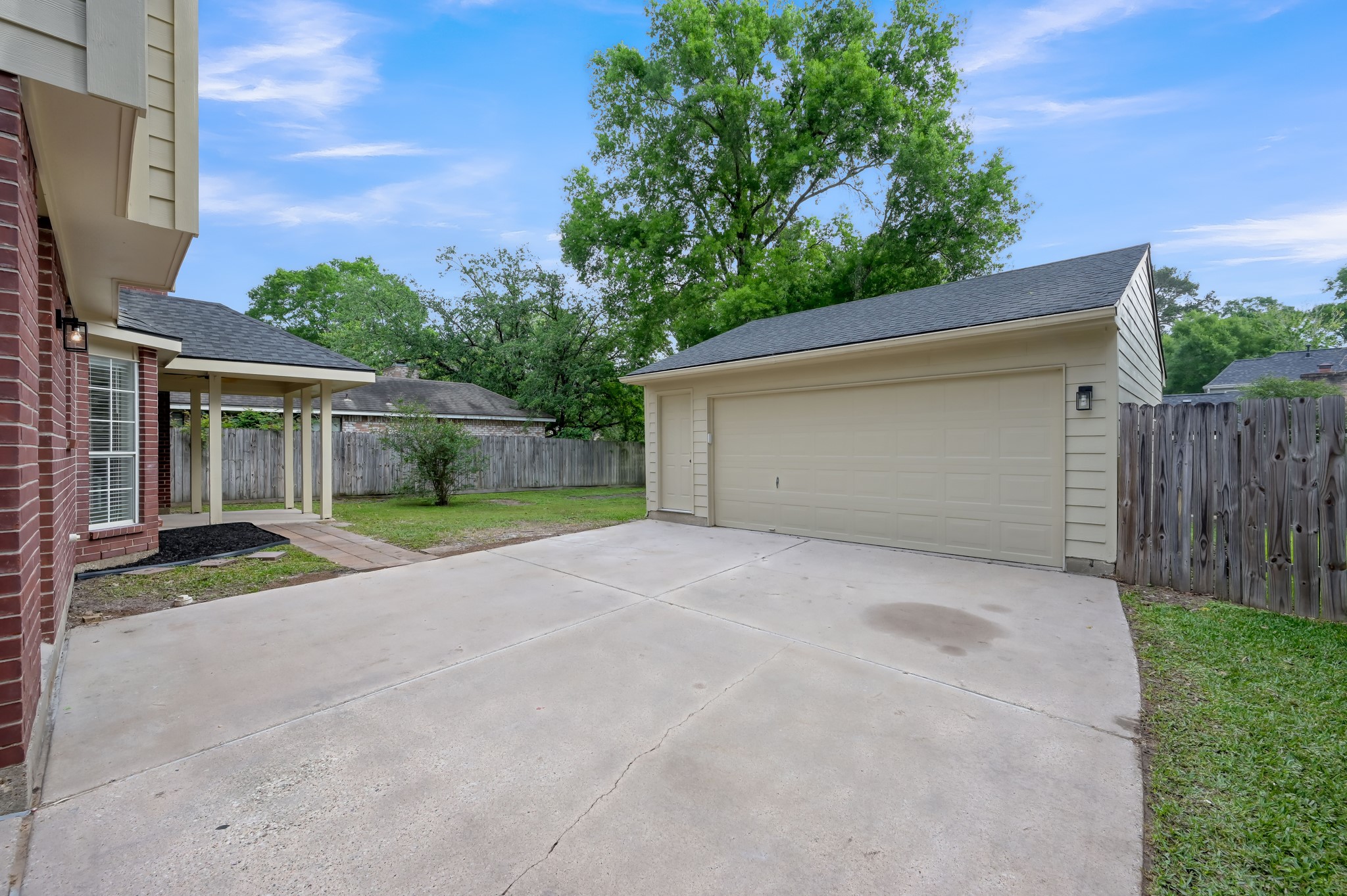 114 Regency Way Conroe, TX 77304 - Photo 45 of 48 Long driveway and plenty of extra parking space leading to the oversized detached garage.