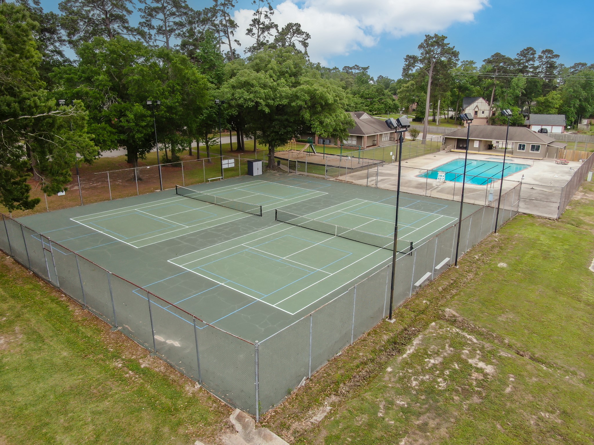 114 Regency Way Conroe, TX 77304 - Photo 47 of 48 Rivershire Community Pool, Tennis Courts, playground and clubhouse.