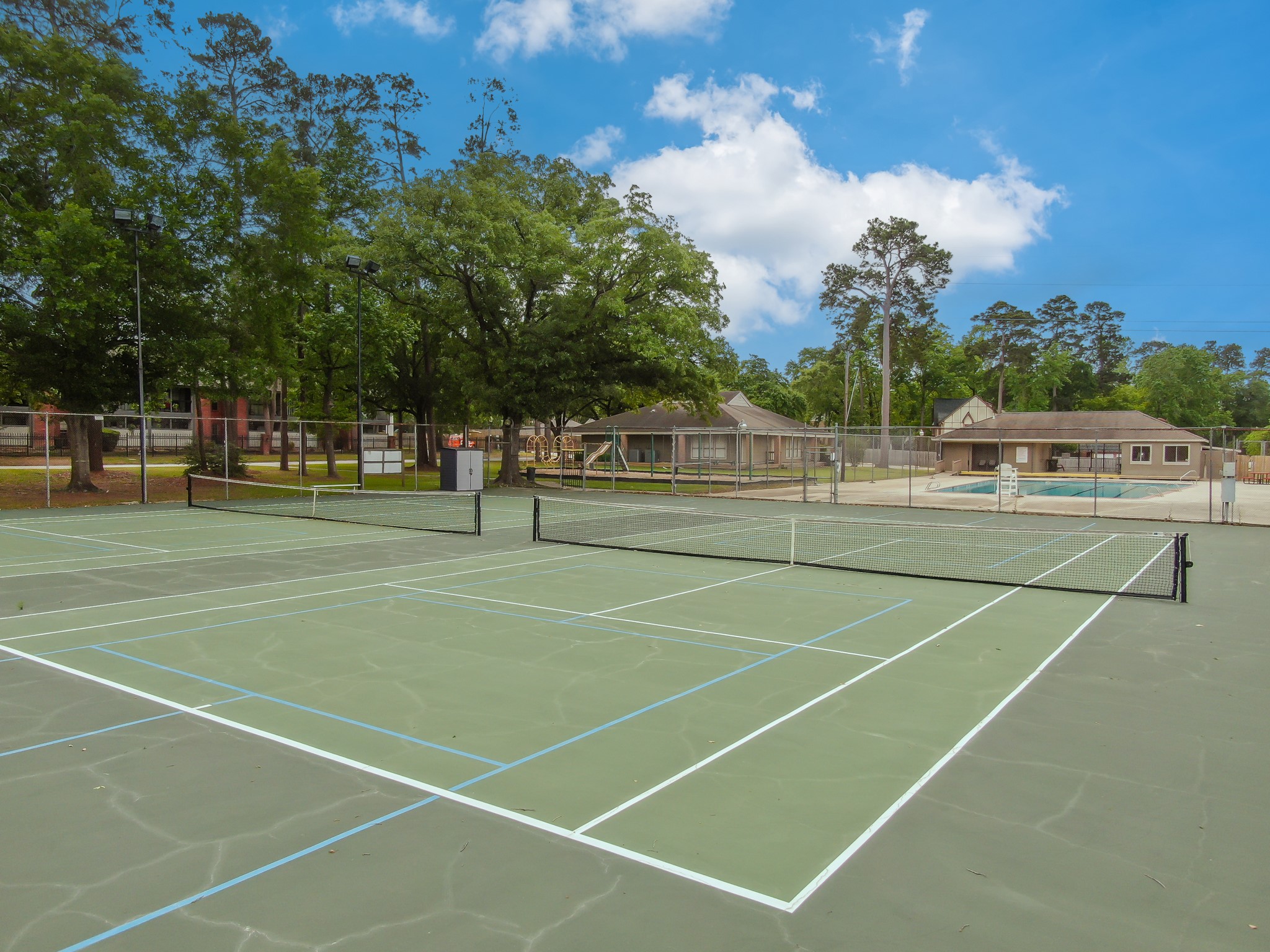 114 Regency Way Conroe, TX 77304 - Photo 48 of 48 Rivershire Community Pool, Tennis Courts, playground and clubhouse.