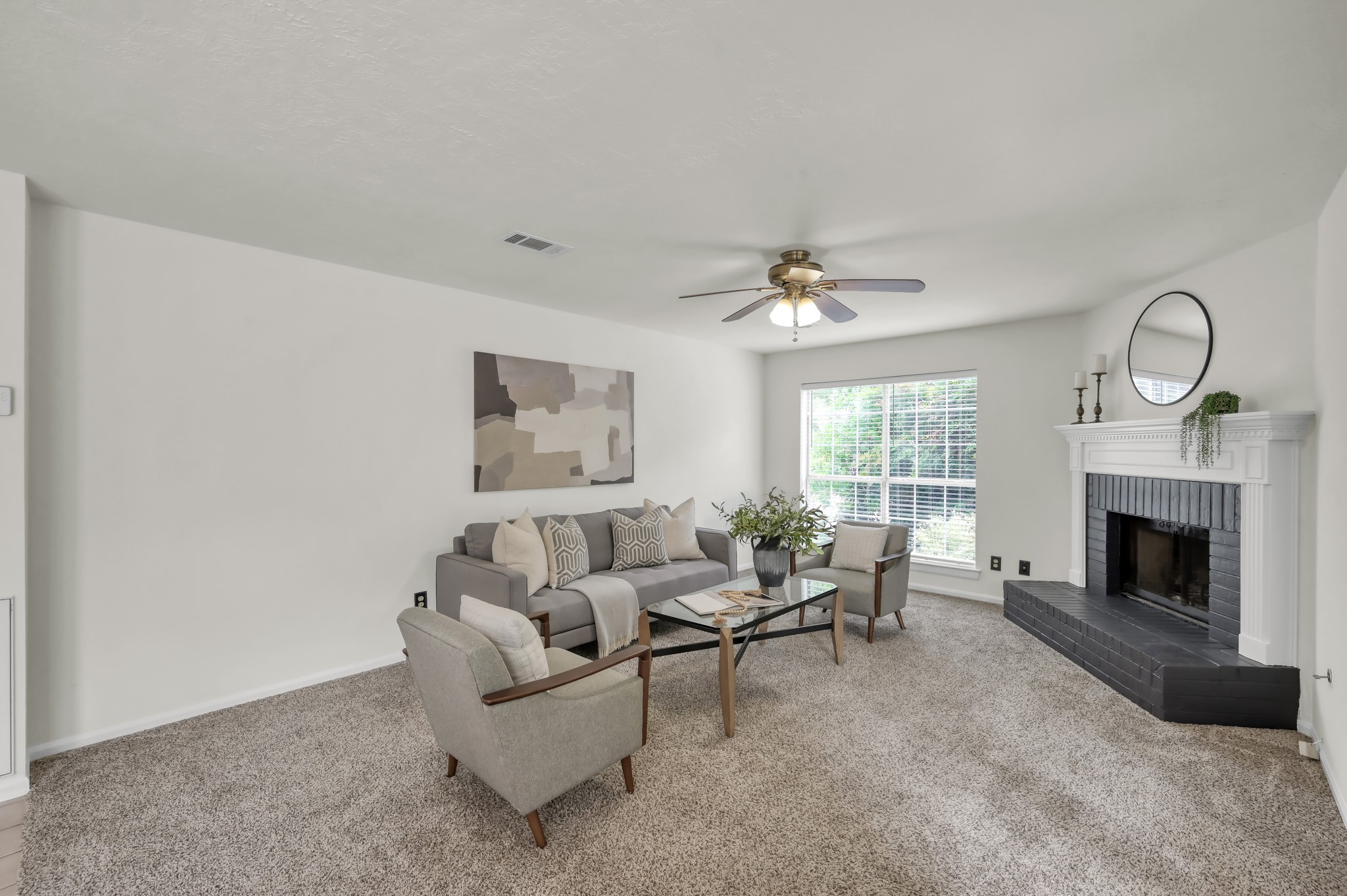 114 Regency Way Conroe, TX 77304 - Photo 9 of 48 Spacious living room with cozy wood/gas fire place, double doors leading to covered back patio and ceiling fan.