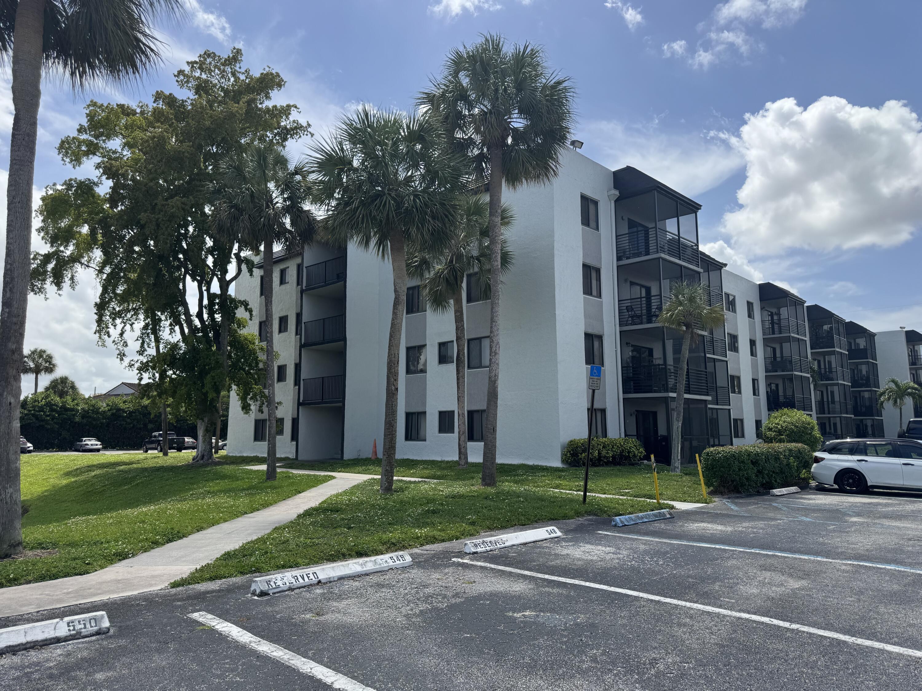 3710 North Pine Island Road, Unit 122 Sunrise, FL 33351 - Photo 1 of 39 a view of a building and a yard