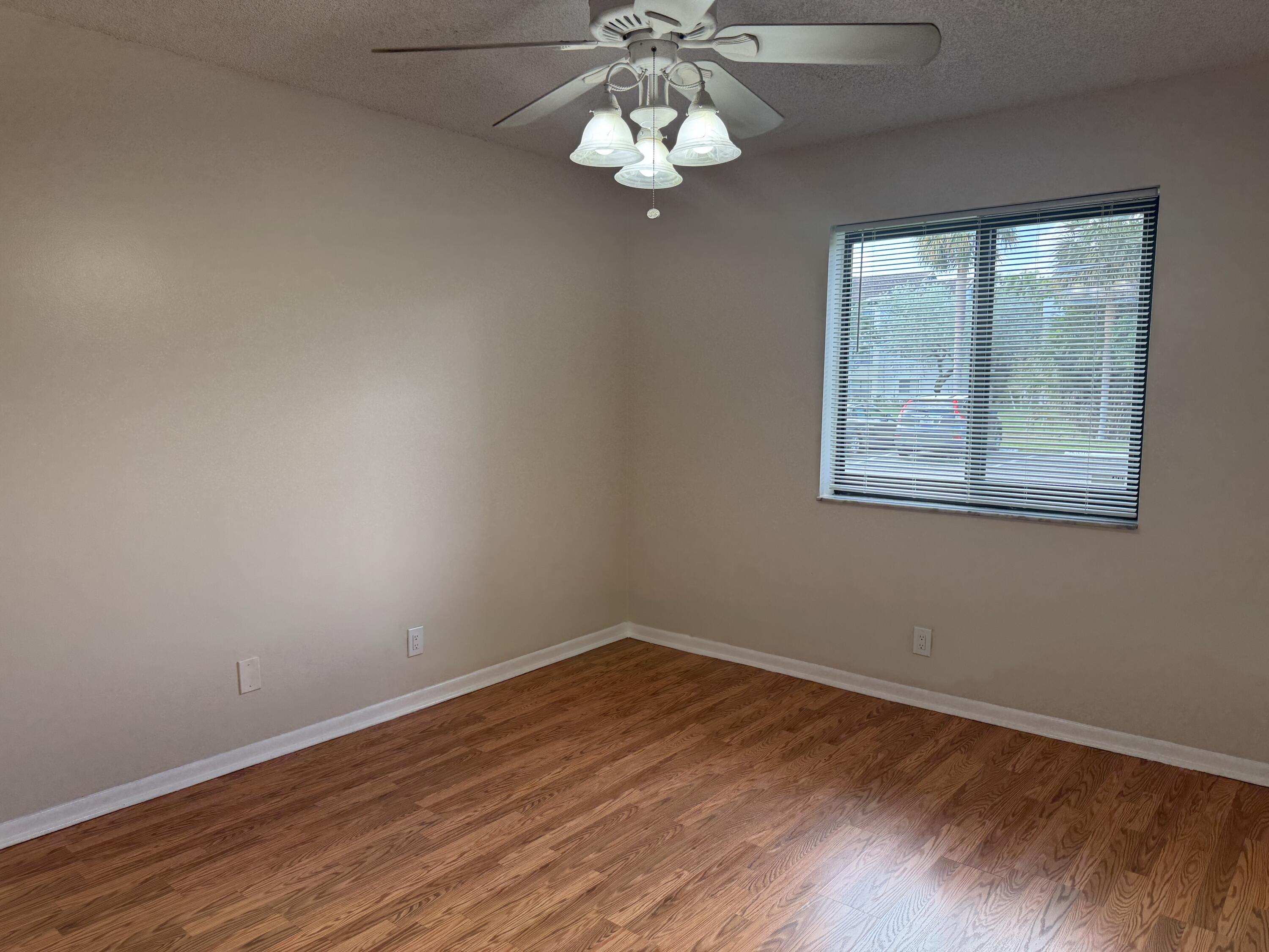 3710 North Pine Island Road, Unit 122 Sunrise, FL 33351 - Photo 12 of 39 a view of wooden floor chandelier and windows in a room