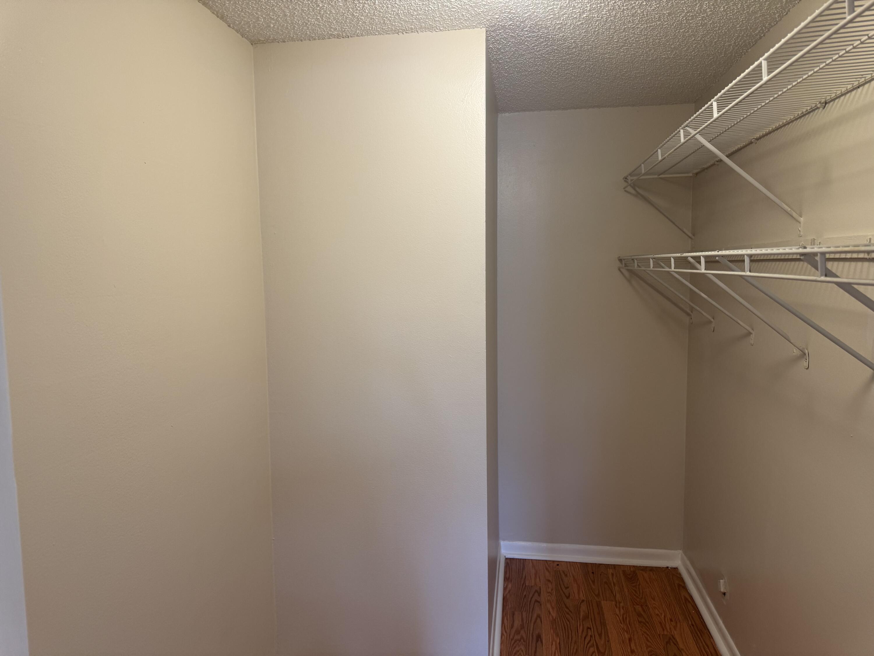 3710 North Pine Island Road, Unit 122 Sunrise, FL 33351 - Photo 13 of 39 a view of walk in closet with empty racks