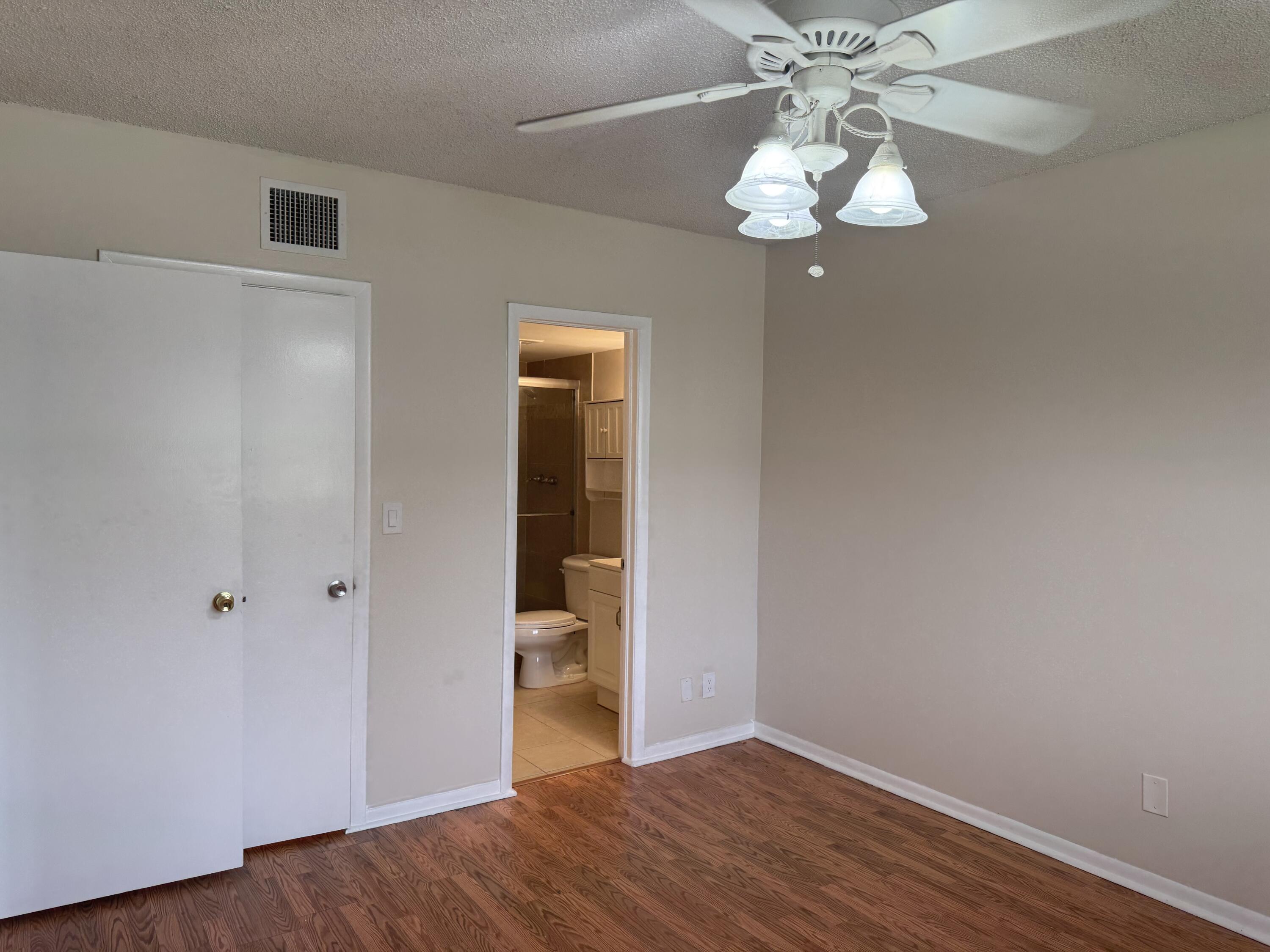 3710 North Pine Island Road, Unit 122 Sunrise, FL 33351 - Photo 15 of 39 a view of a hallway with wooden floor and chandelier
