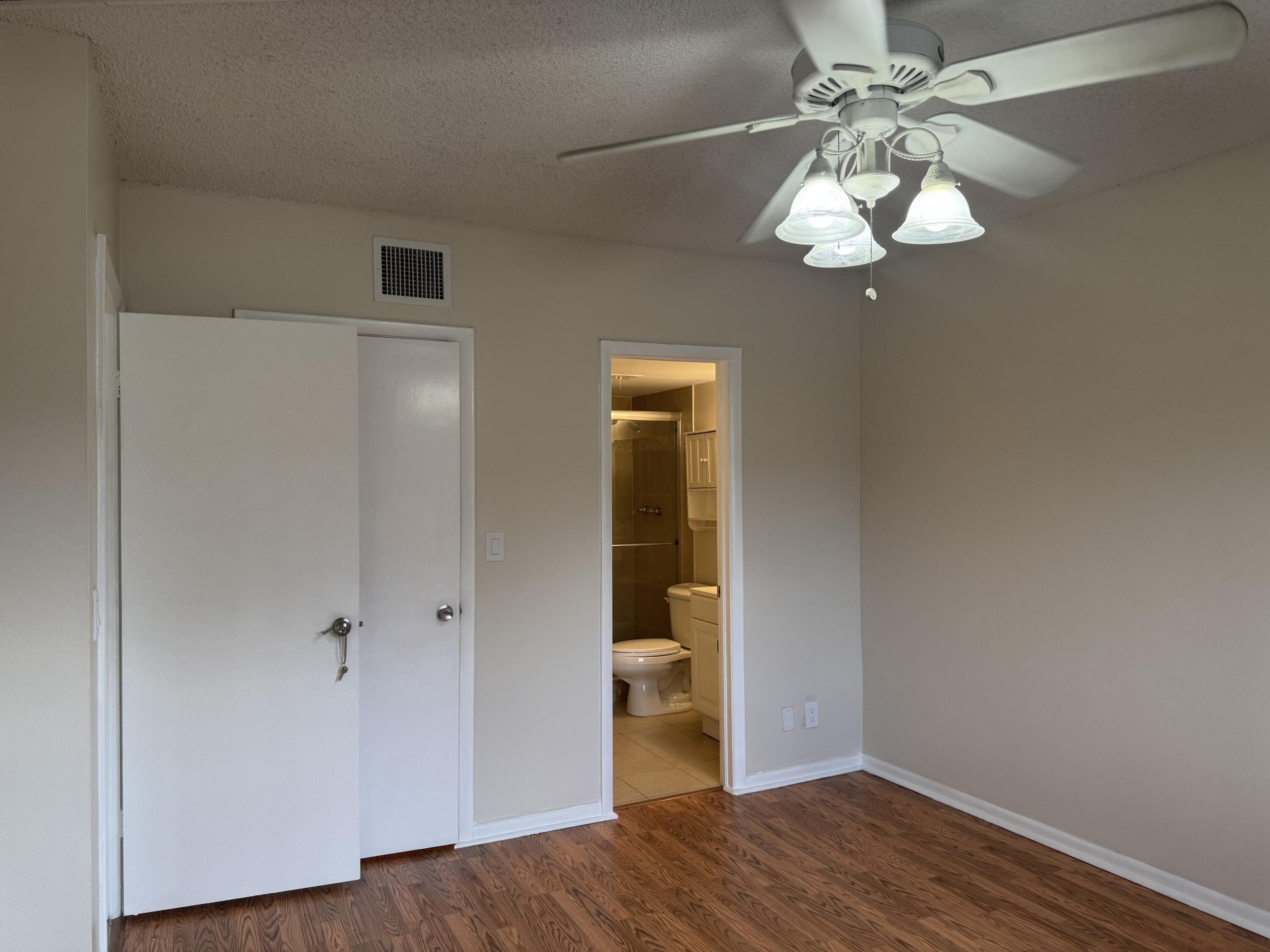 3710 North Pine Island Road, Unit 122 Sunrise, FL 33351 - Photo 16 of 39 wooden floor in an empty room with a window