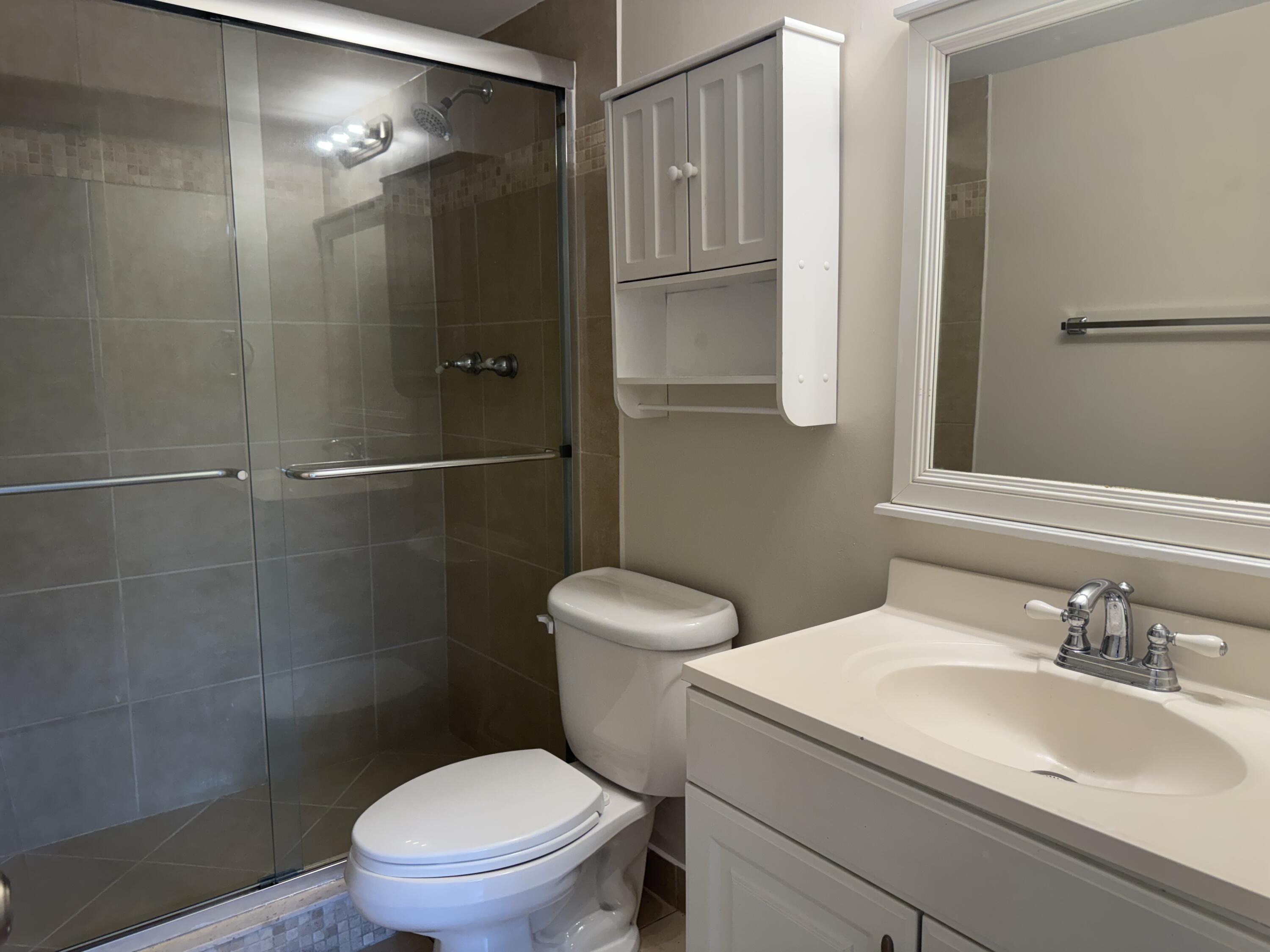 3710 North Pine Island Road, Unit 122 Sunrise, FL 33351 - Photo 18 of 39 a bathroom with a sink a toilet and shower