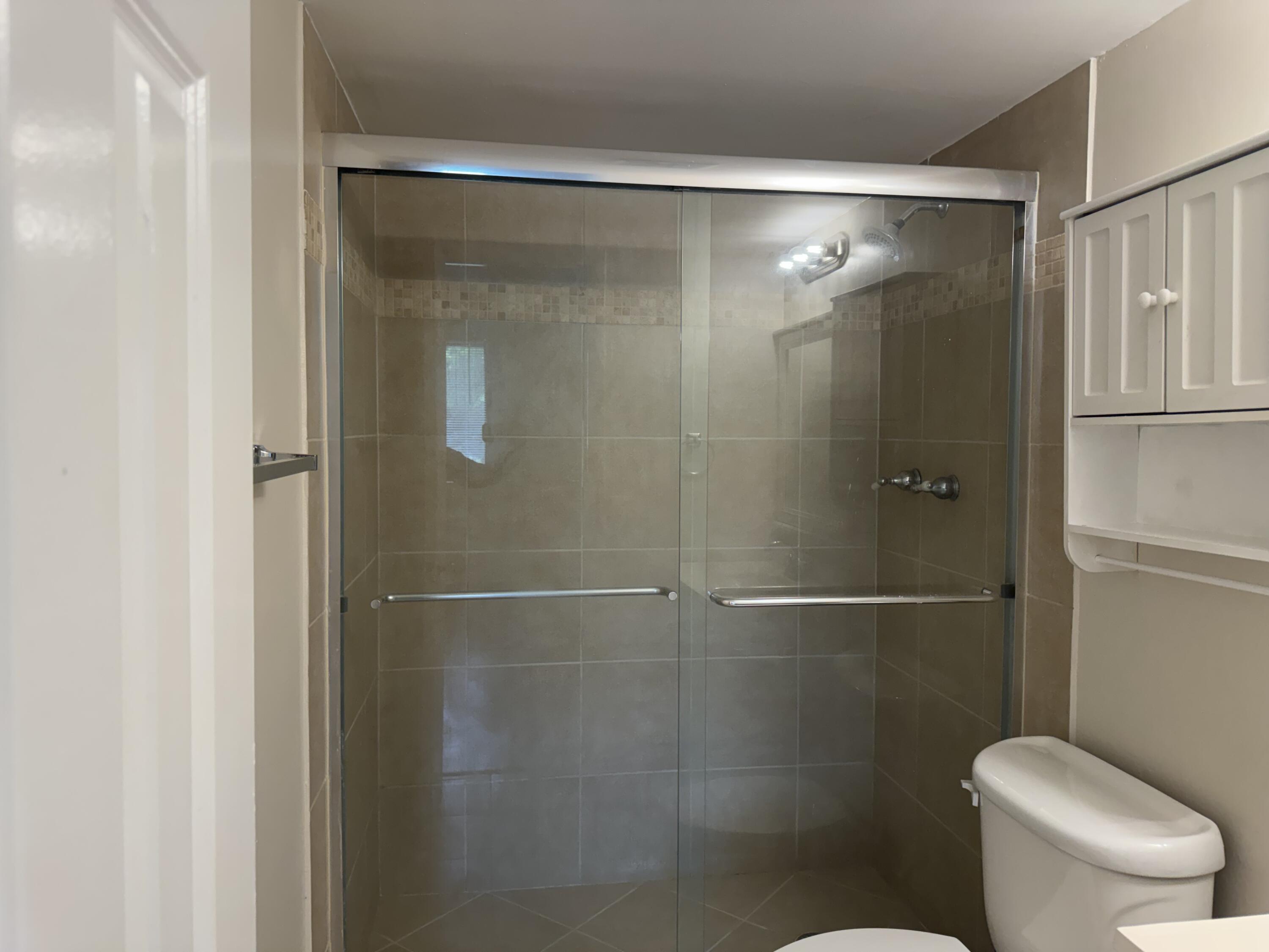 3710 North Pine Island Road, Unit 122 Sunrise, FL 33351 - Photo 19 of 39 a bathroom with a shower and a toilet
