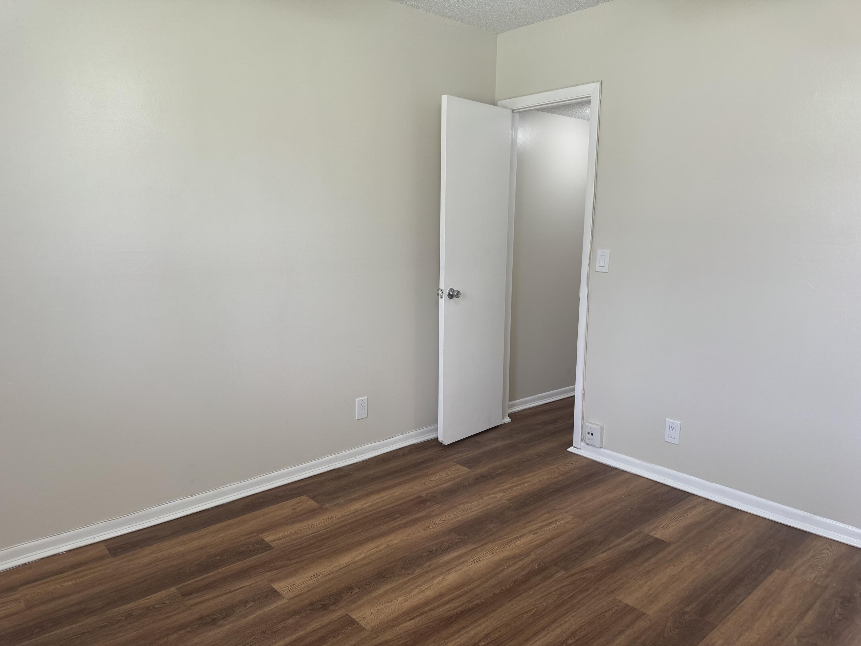 3710 North Pine Island Road, Unit 122 Sunrise, FL 33351 - Photo 25 of 39 a view of an empty room with wooden floor