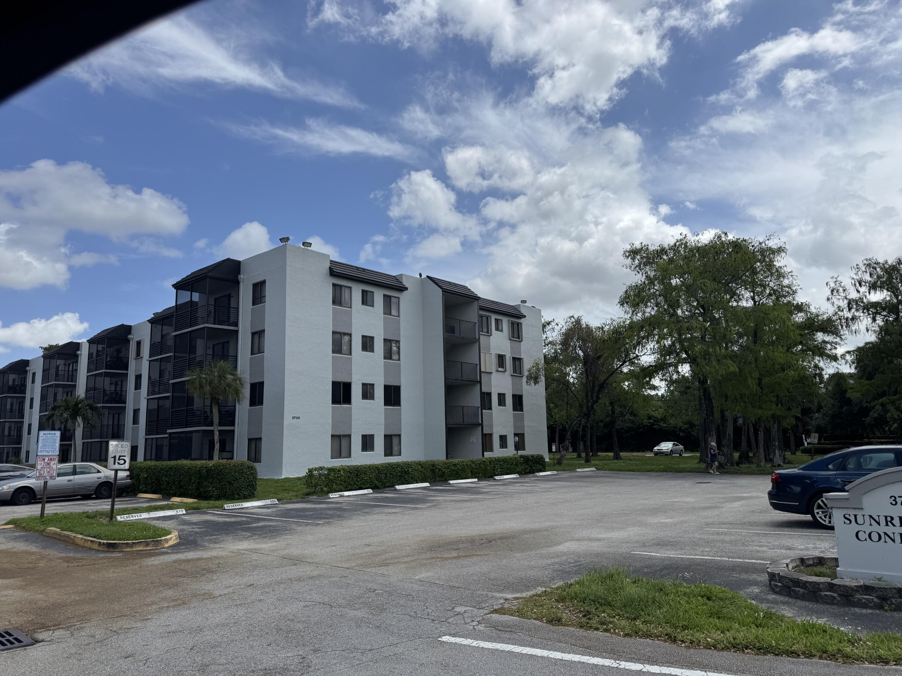 3710 North Pine Island Road, Unit 122 Sunrise, FL 33351 - Photo 37 of 39 a view of a building with a yard