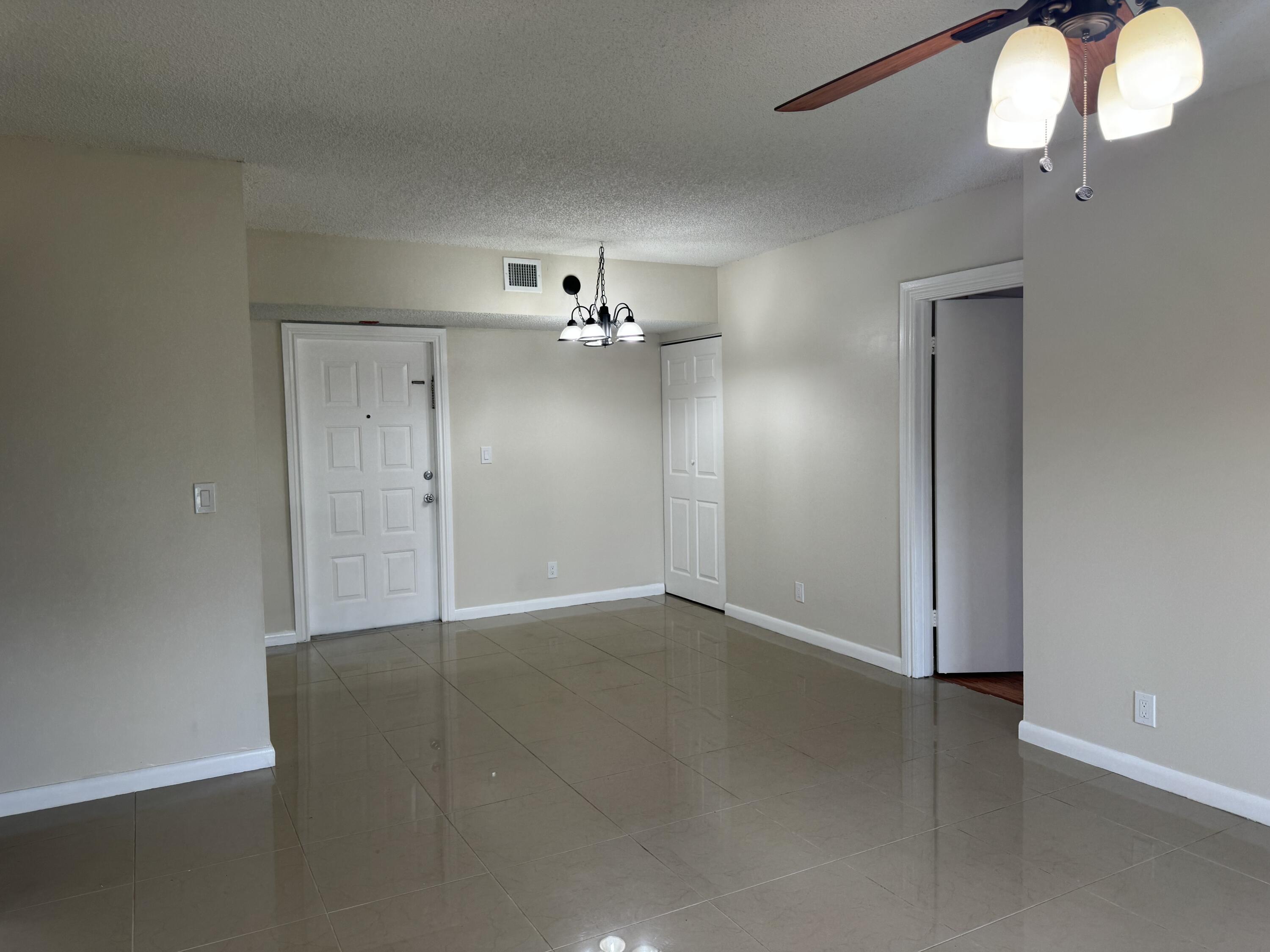 3710 North Pine Island Road, Unit 122 Sunrise, FL 33351 - Photo 4 of 39 a view of an empty room with wooden floor