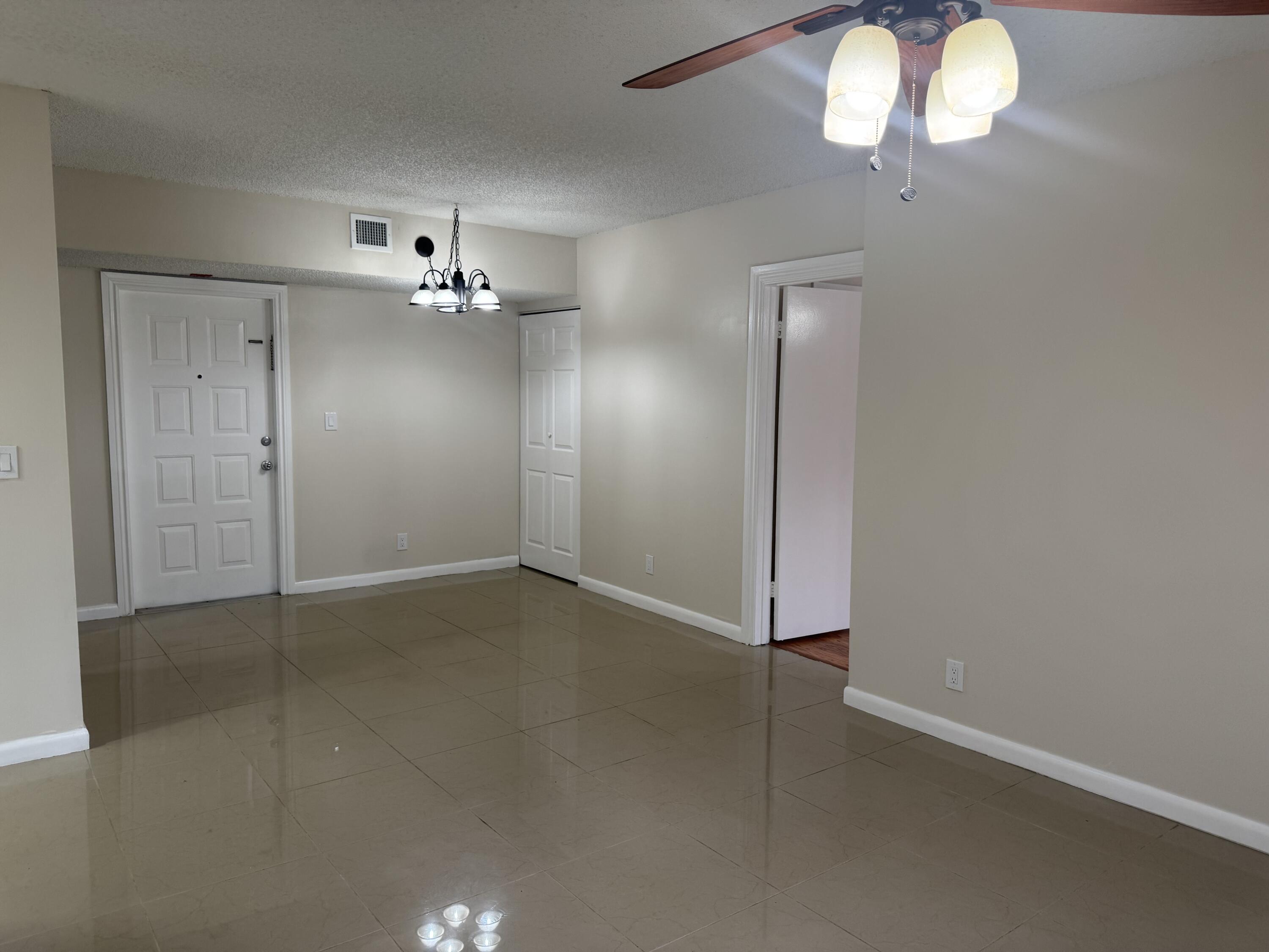 3710 North Pine Island Road, Unit 122 Sunrise, FL 33351 - Photo 6 of 39 wooden floor in an empty room