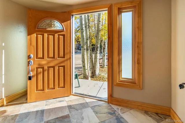 a front view of a house with a yard deck and furniture