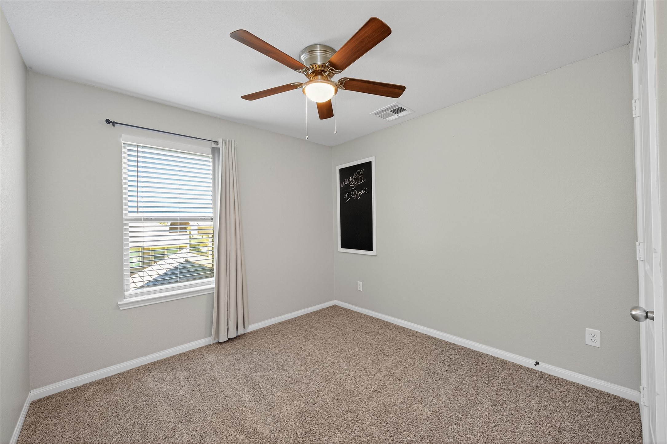 26108 Morgan Cemetery Road Cleveland, TX 77328 - Photo 19 of 39 an empty room with ceiling fan and windows