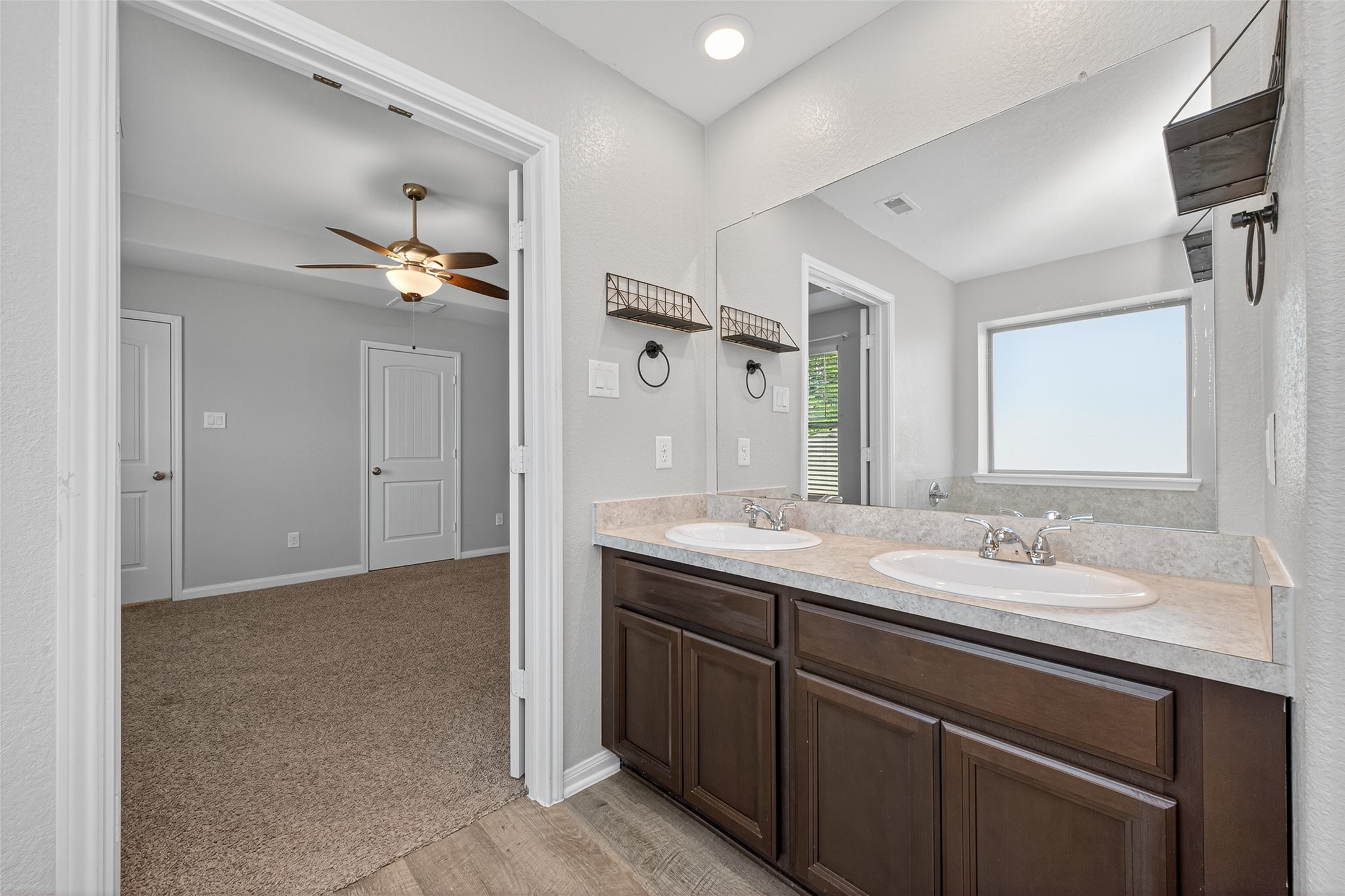 26108 Morgan Cemetery Road Cleveland, TX 77328 - Photo 26 of 39 a bathroom with a double vanity sink and a mirror
