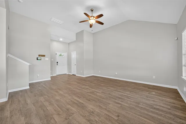 an empty room with fan and a ceiling fan