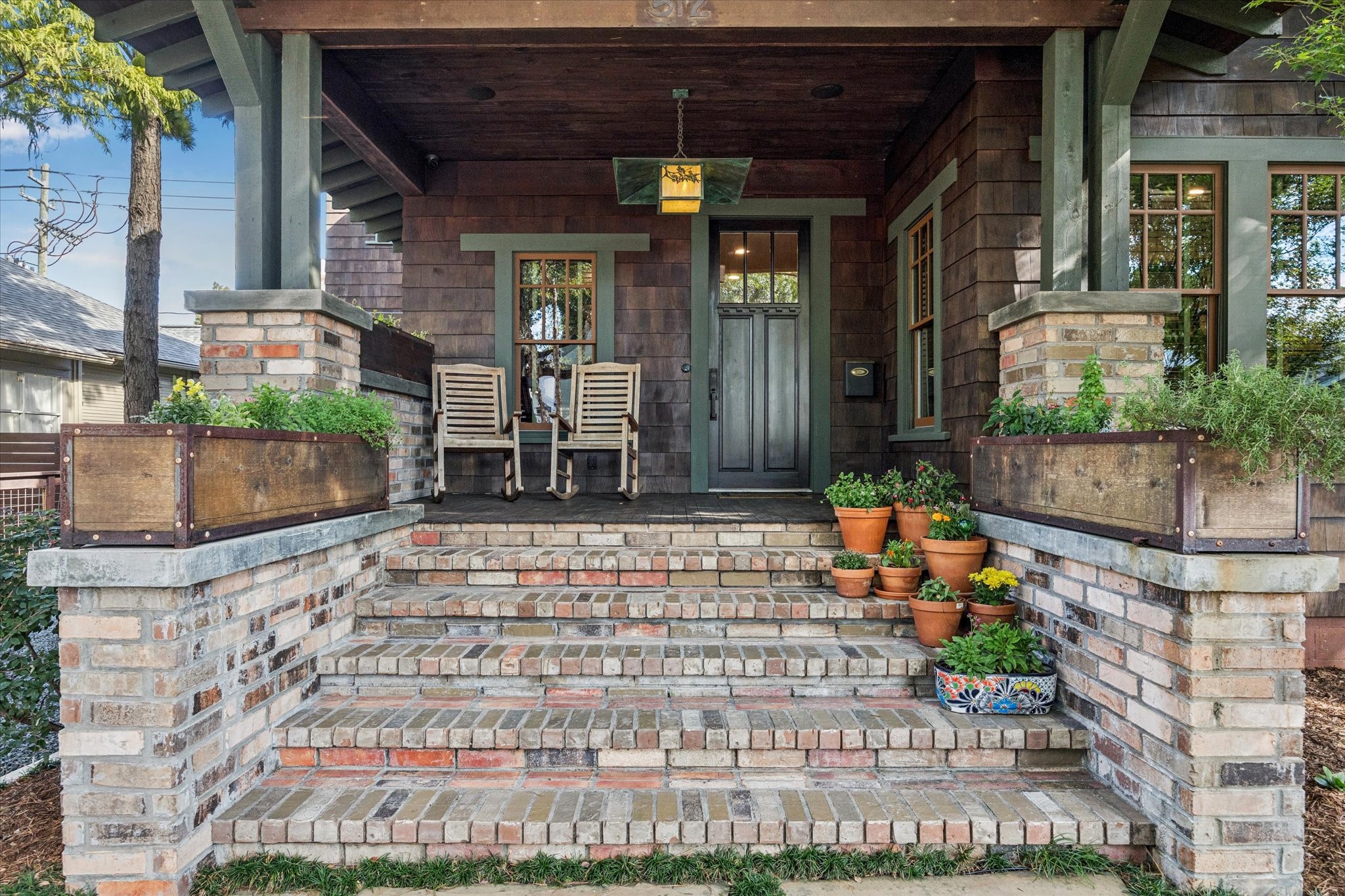 512 Archer Street Houston, TX 77009 - Photo 38 of 40 Beautiful covered front porch with a striking statement light fixture and plenty of room for seating—perfect for relaxing and enjoying the outdoors.