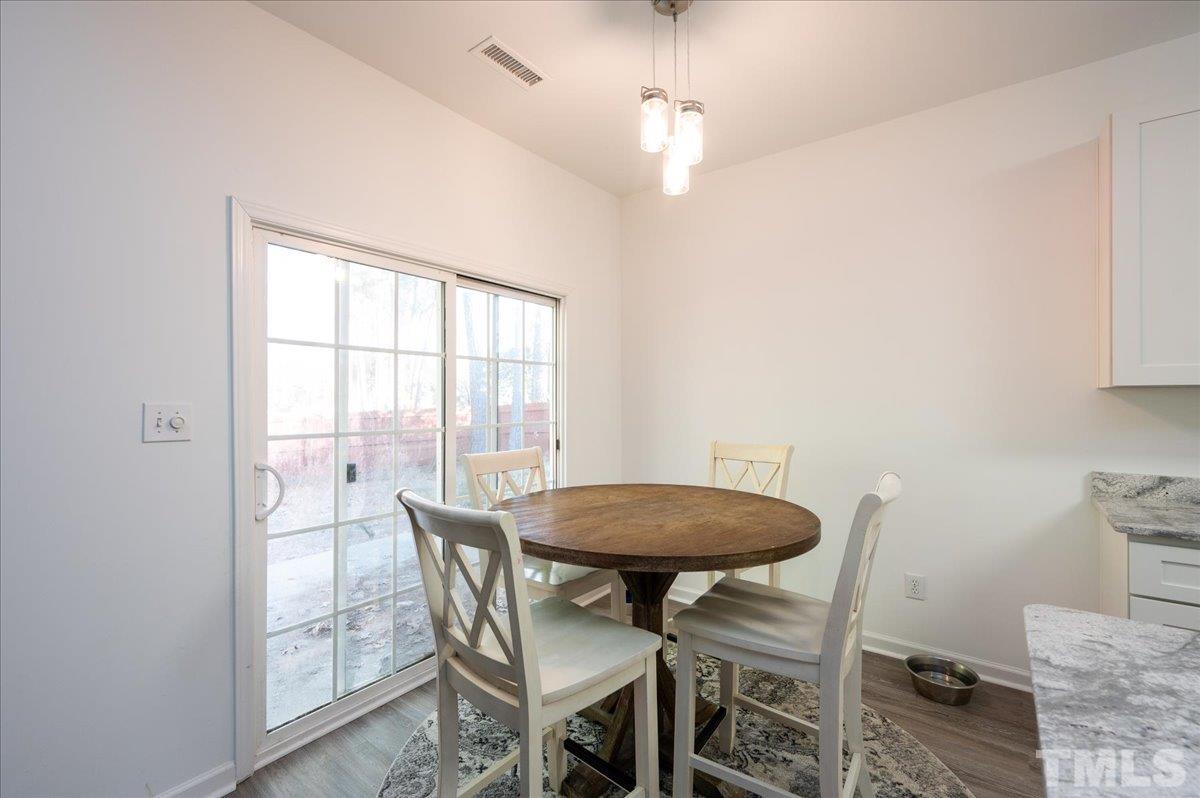 8616 Neuse Stone Drive Raleigh, NC 27616 - Photo 12 of 24 a view of a dining room with furniture and a window