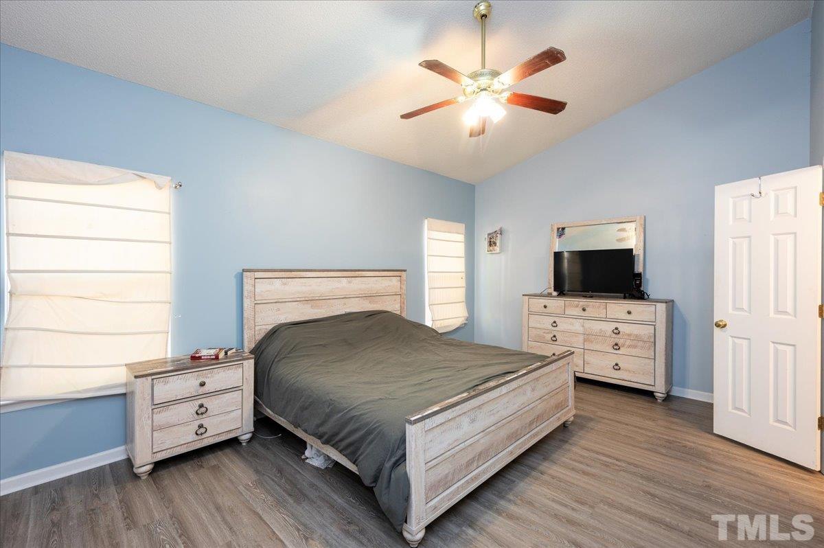 8616 Neuse Stone Drive Raleigh, NC 27616 - Photo 17 of 24 a bedroom with a bed and a flat screen tv