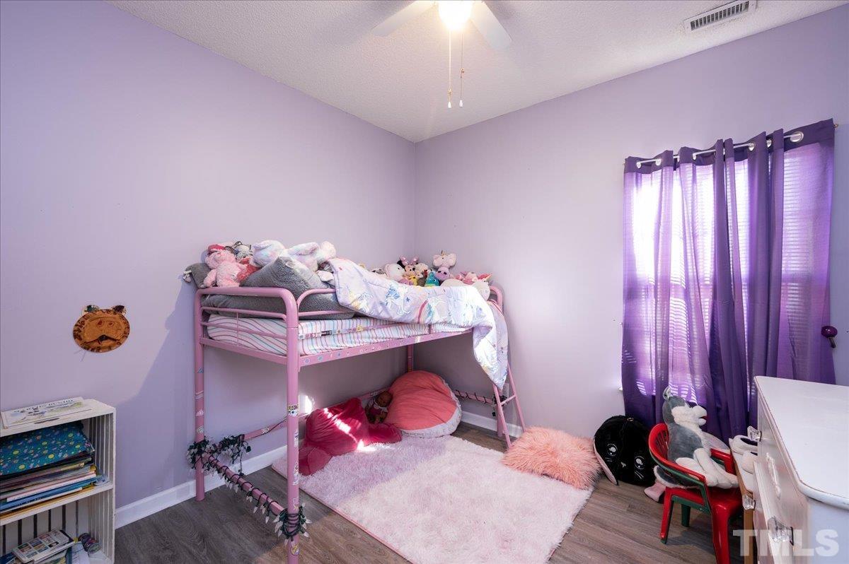 8616 Neuse Stone Drive Raleigh, NC 27616 - Photo 20 of 24 a bedroom with furniture and a window