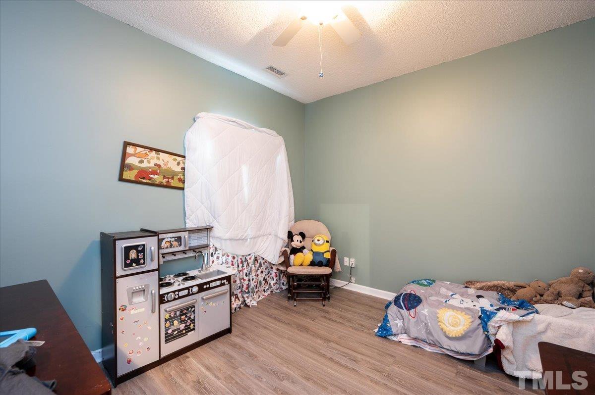 8616 Neuse Stone Drive Raleigh, NC 27616 - Photo 21 of 24 a living room with furniture and a wooden floor