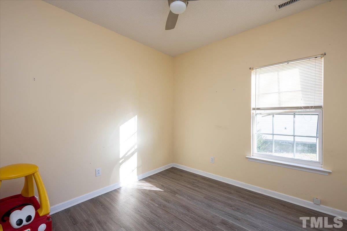 8616 Neuse Stone Drive Raleigh, NC 27616 - Photo 22 of 24 an empty room with wooden floor and windows