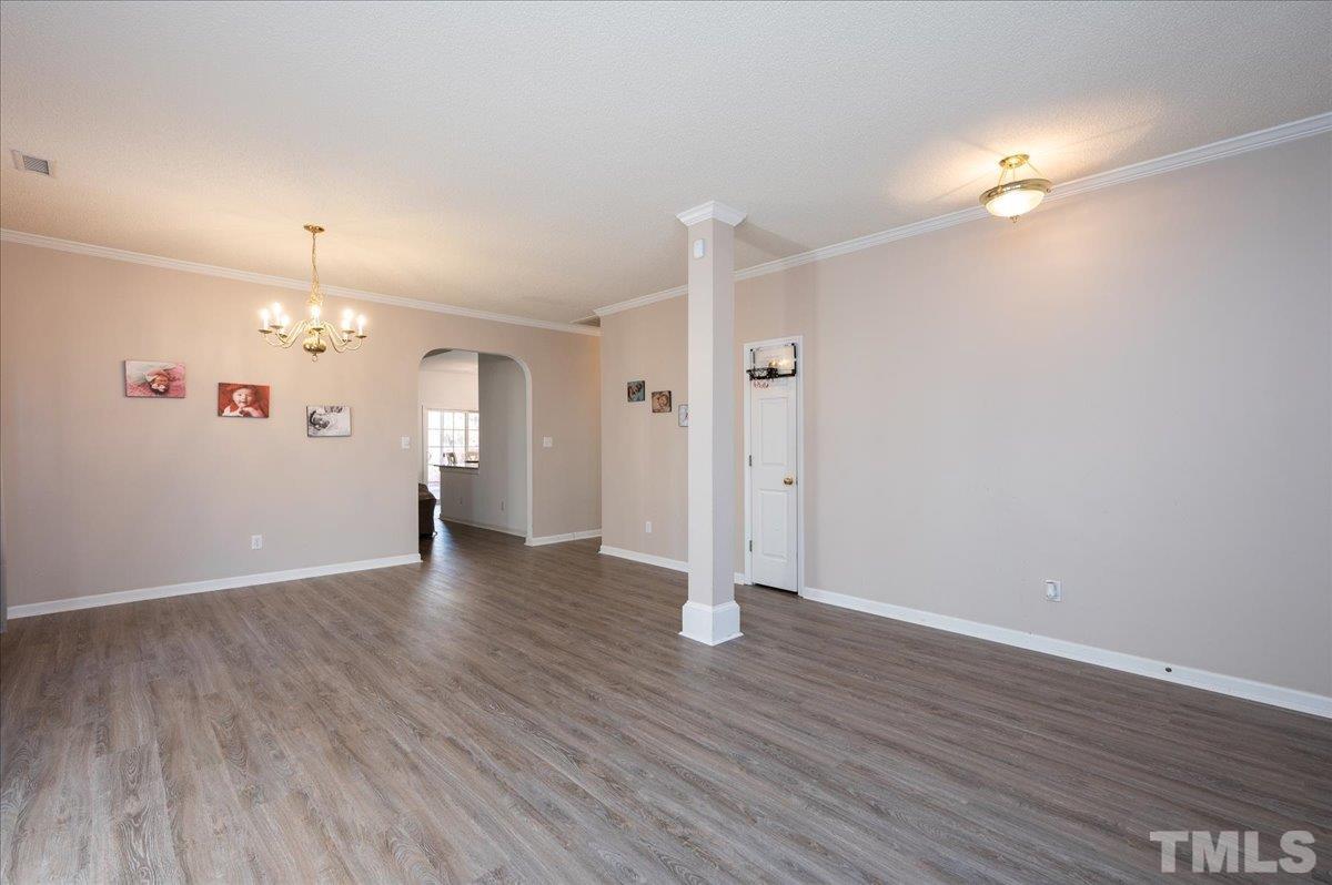 8616 Neuse Stone Drive Raleigh, NC 27616 - Photo 5 of 24 wooden floor in an empty room with a window