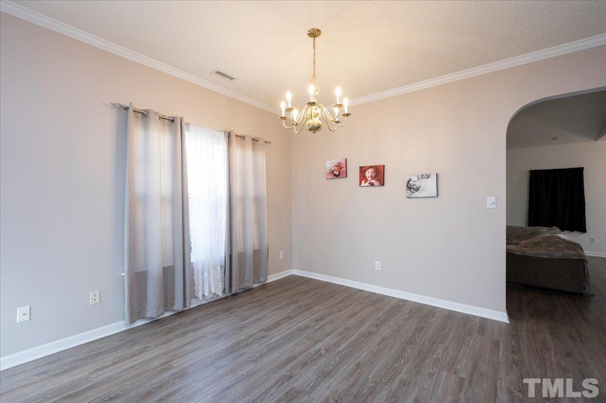 8616 Neuse Stone Drive Raleigh, NC 27616 - Photo 6 of 24 wooden floor in an empty room with a window