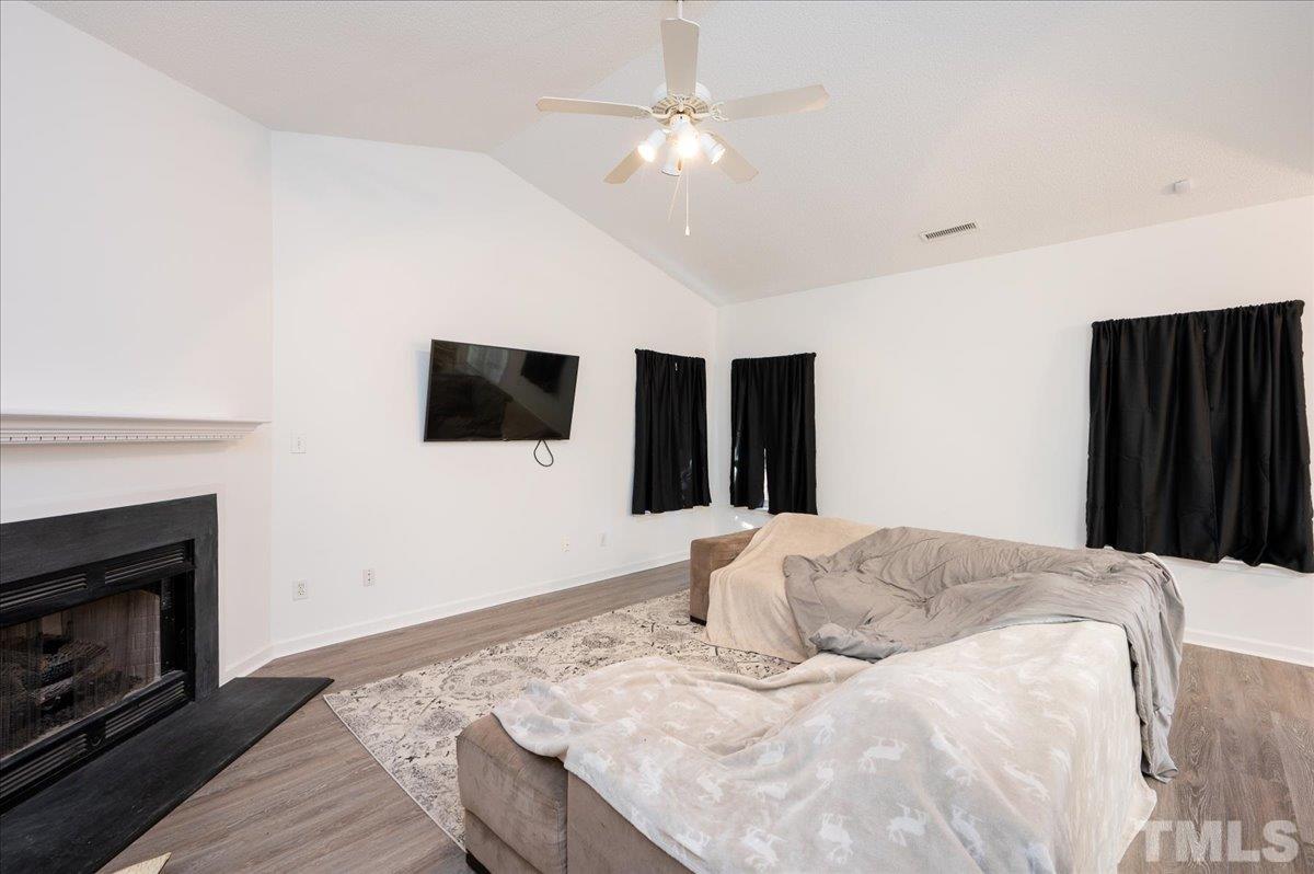 8616 Neuse Stone Drive Raleigh, NC 27616 - Photo 8 of 24 a bedroom with a bed and a flat screen tv