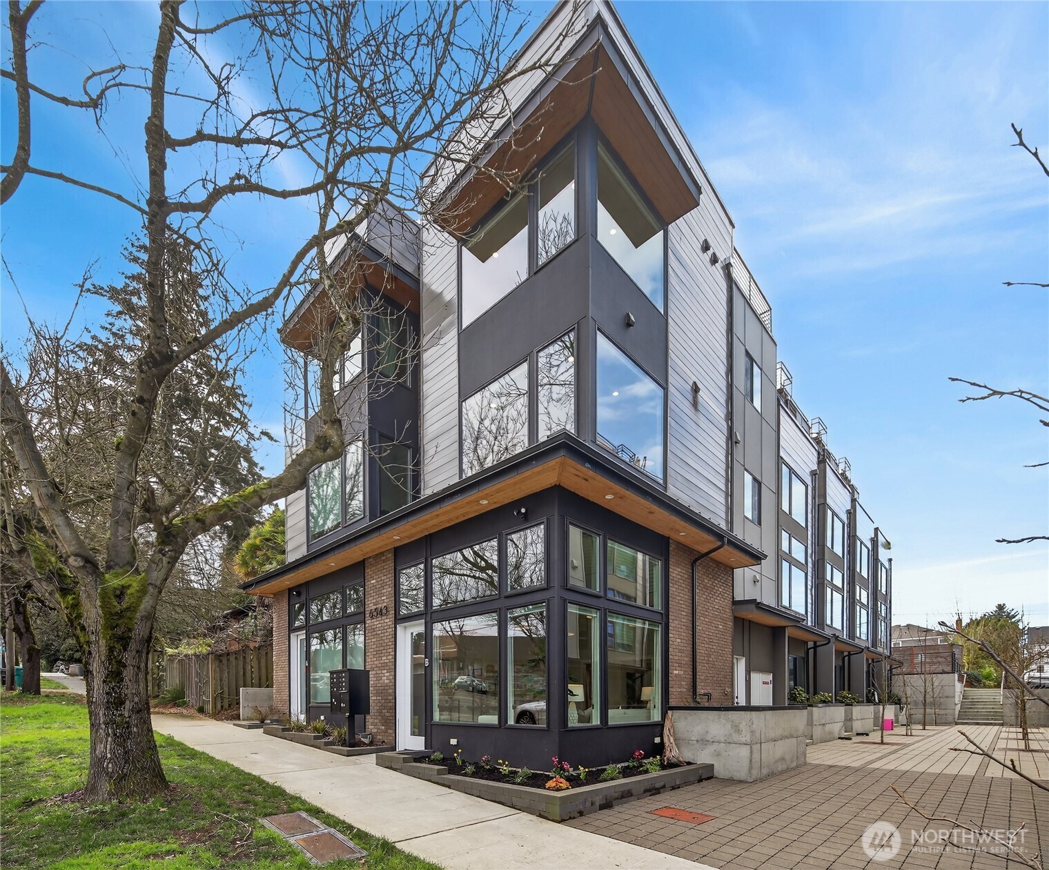 6543 35th Avenue Southwest, Unit B Seattle, WA 98126 - Photo 1 of 37 a front view of a house with a yard