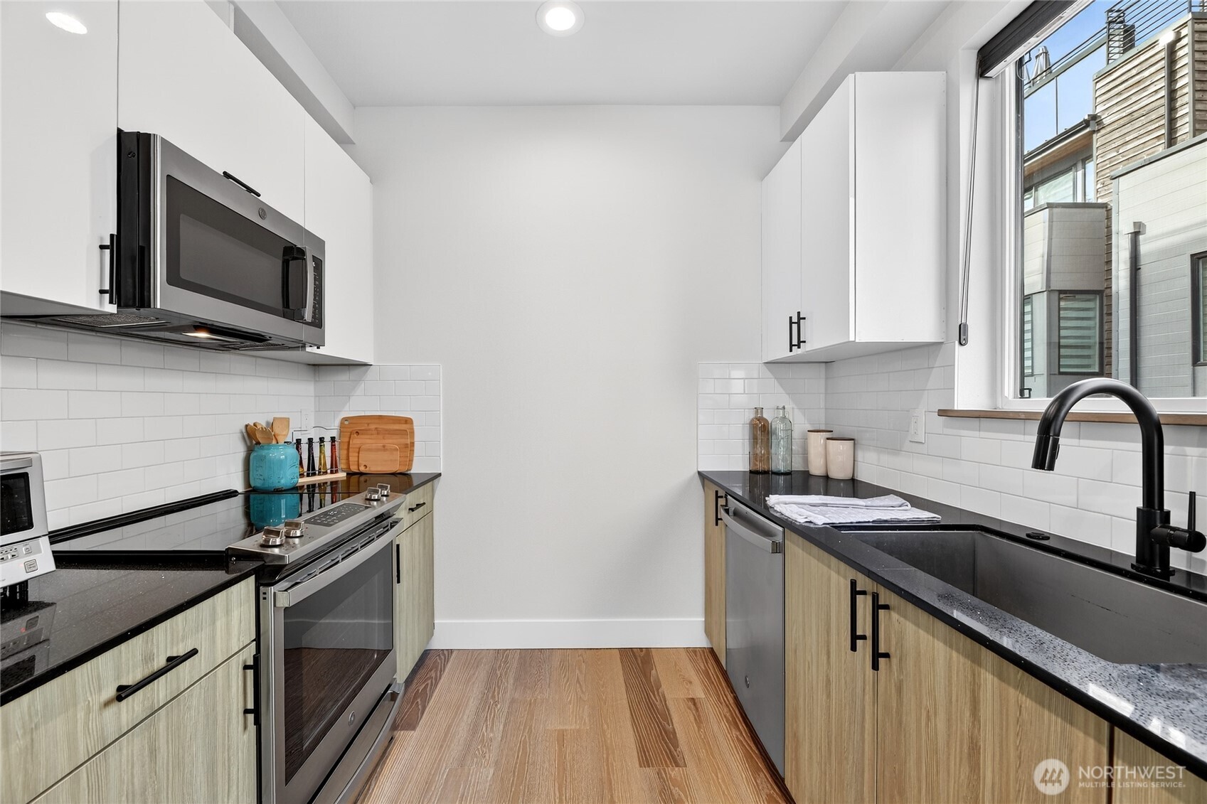 6543 35th Avenue Southwest, Unit B Seattle, WA 98126 - Photo 18 of 37 a kitchen with stainless steel appliances granite countertop a sink stove and microwave